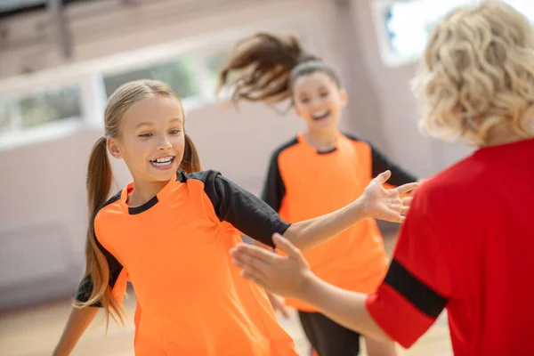 Niños en ropa deportiva brillante disfrutando del entrenamiento en el gimnasio — Foto de Stock