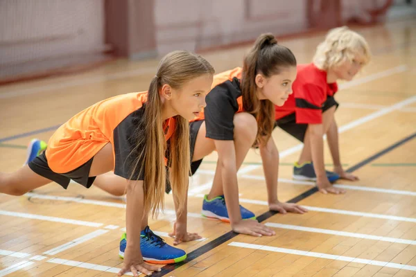 Kids in bright sportswear waiting to start the game — Stock Photo, Image