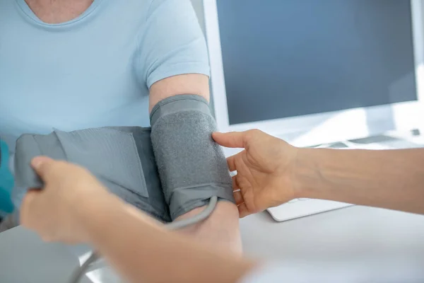 Close up picture of measuring blood-pressure to elderly woman