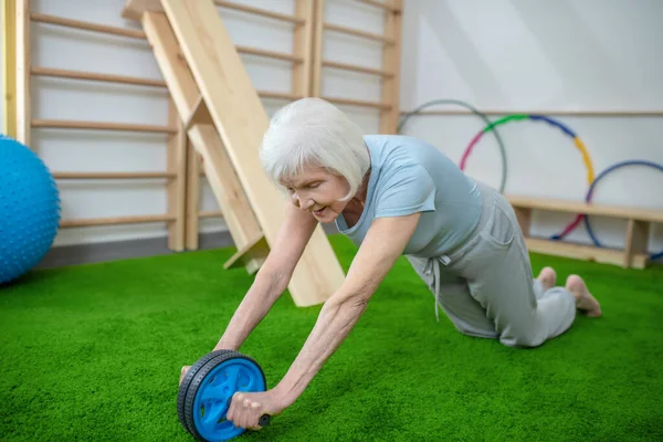 Elderly woman exercising in a rehabilitation center