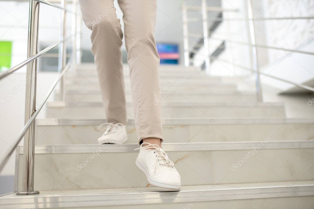 Close up of womans legs going downstairs