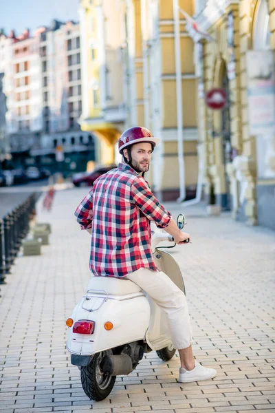 Человек уезжает на своем белом скутере — стоковое фото