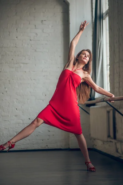 Jovem mulher esticando as costas enquanto dança — Fotografia de Stock