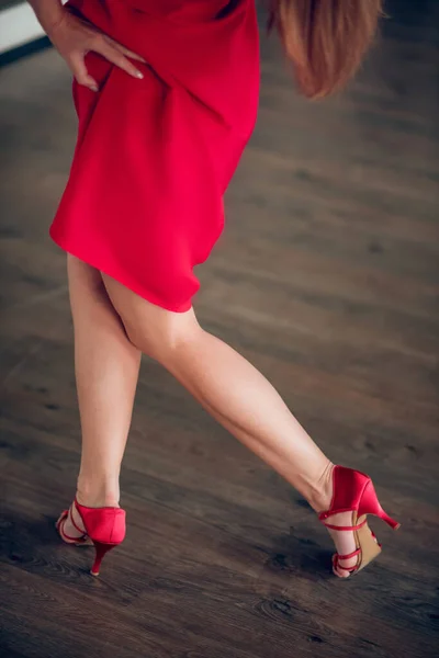 Woman wearing red dress and heels during the rehearsal Stock Image