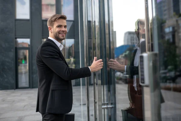 Elegante homem de negócios entrando no centro de negócios e se sentindo satisfeito — Fotografia de Stock