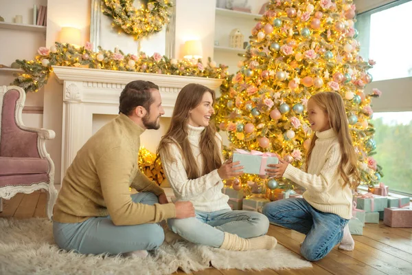 Schattig meisje geven nieuwjaar cadeau aan haar ouders — Stockfoto