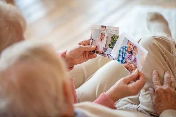 Close up picture of people looking through old photographs — Stock Photo, Image