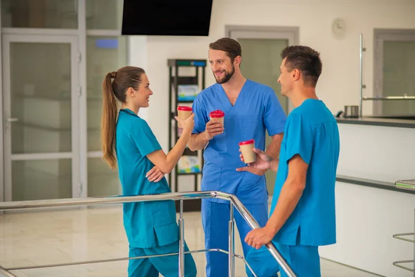 Group of doctors having coffee while having a break at work