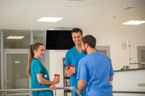 Group of doctors having coffee while having a break at work