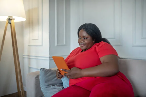 Plus size african american woman spending time on internet