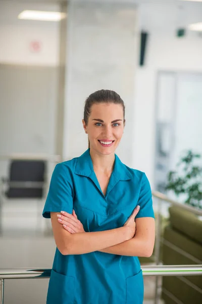 Csinos fiatal nő orvos kék egyenruhában érzés pozitív — Stock Fotó