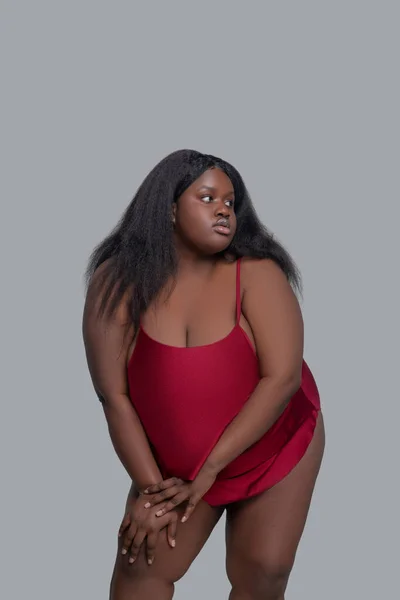 Afrikansk amerikansk ung kvinna i röda underkläder tittar åt sidan — Stockfoto