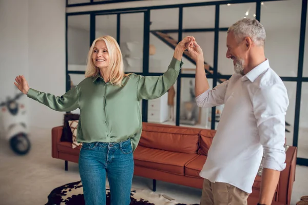 Hombre y mujer bailando en la habitación y sintiéndose bien — Foto de Stock