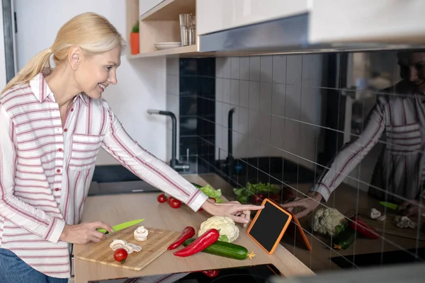 Mujer parada en la cocina y teniendo un video taller culinario — Foto de Stock