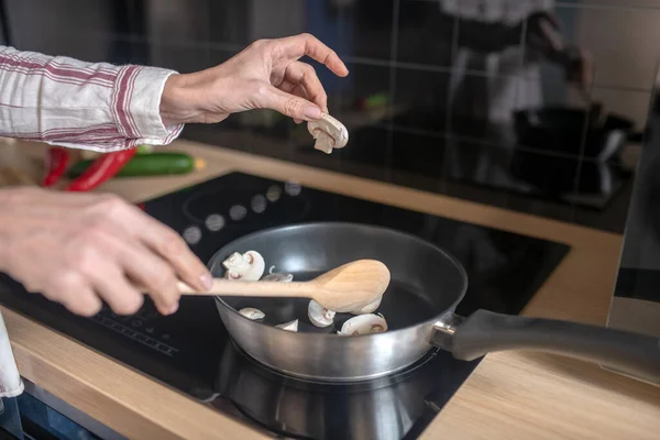 Foto ravvicinata di una donna che mescola il cibo su una padella — Foto Stock