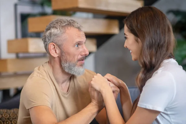 Bearded man and young woman enjoying being together — Stock Photo, Image