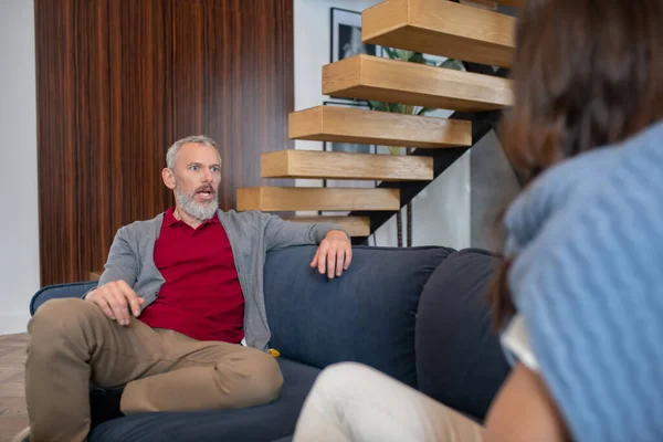 Teleurgesteld man met baard praat met zijn jonge vrouw — Stockfoto