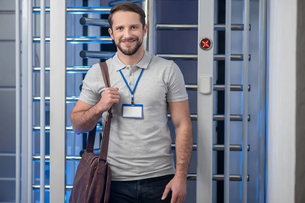 Happy male employee standing at checkpoint — Stock Photo, Image