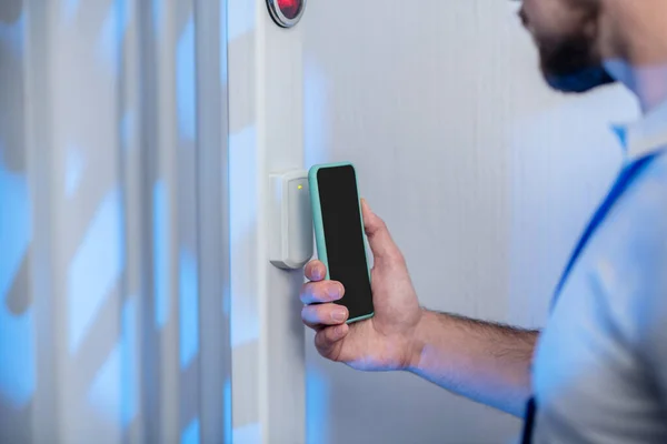 Male hand applying smartphone to scanner — Stock Photo, Image