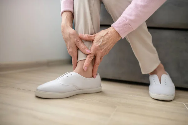 Close up imagem de mulheres mãos tocando sua perna — Fotografia de Stock