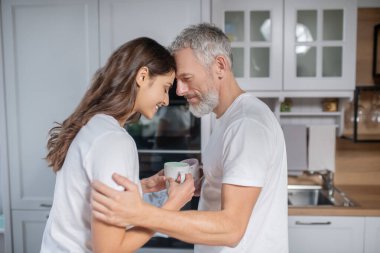 Man and woman hugging each other while having coffee clipart