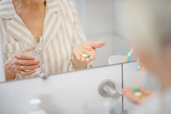 Feche o quadro da mão de mulheres com pílulas nele — Fotografia de Stock