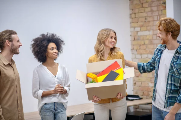 Group of colleagues wishing good luck to their leaving coworker