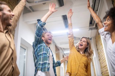 Gorup of cfriends in the corridor looking happy and excited