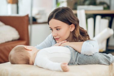 Uyuyan çocuğu izleyen özenli bir anne.
