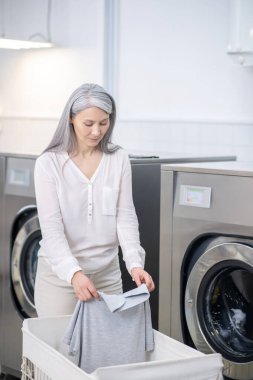 Yıkanmış tişörtte profesyonel görünümü olan bir kadın.