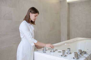 Spa uzmanı banyoyu hazırlıyor.