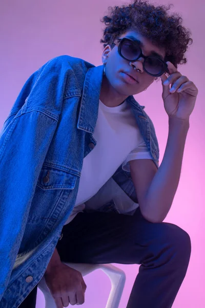 Stylish african american male model in denim jacket posing in studio — Stock Photo, Image