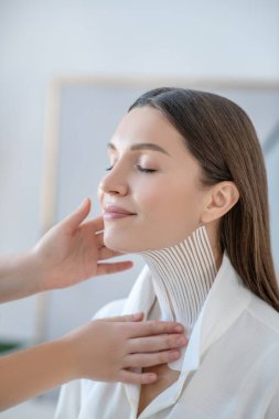 Pretty woman having taping procedures in beauty center