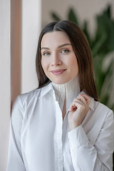 Cute young woman with tapes on her neck looking thoughtful — Stock Fotó