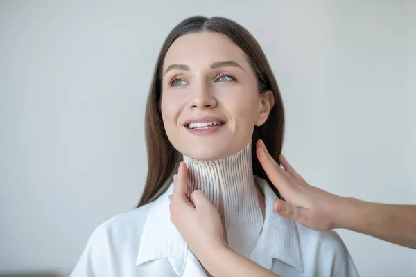 Pretty young woman visiting beauty center and having taping procedure — Stockfoto