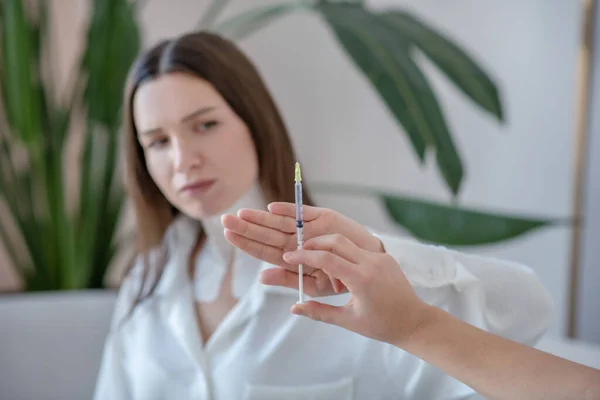 Cute young woman visiting beauty center and rejectong botox injections — Fotografia de Stock