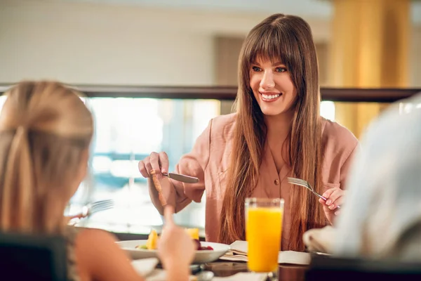 Happy family sitting at the table in the restaurant — Stock Photo, Image