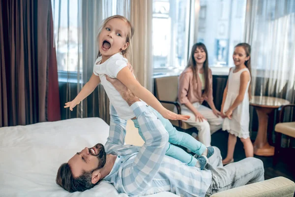 Dad having fun with his daughter and smiling nicely — Stock Photo, Image