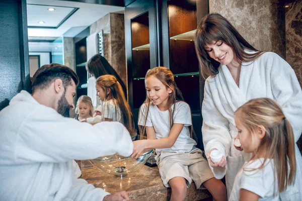 Cute family in bath robes brushing teeth together — Stock Photo, Image