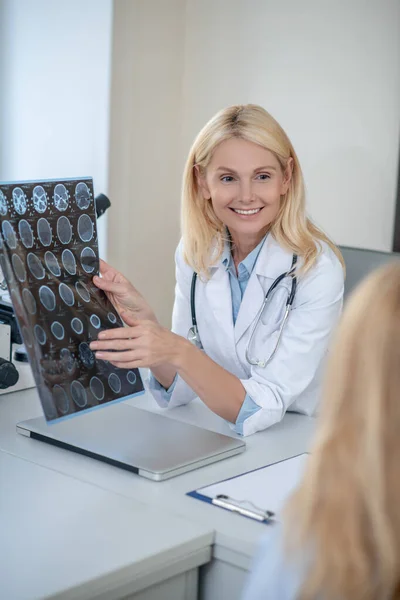 Glädjande läkare visar MRT-skanning för patienten — Stockfoto