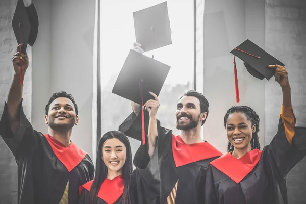 A company of graduates looking happy and cheerful — Stock Photo, Image