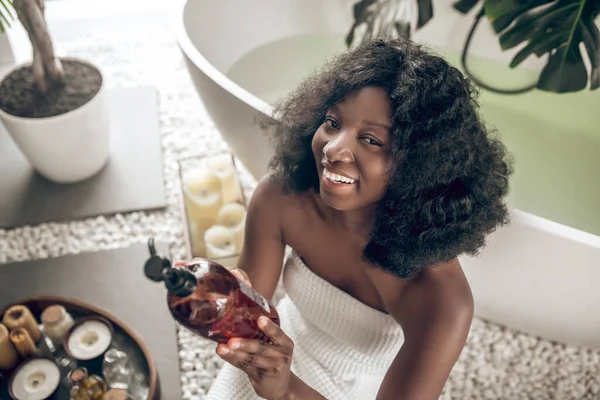 Pretty african american woman with natural beauty products