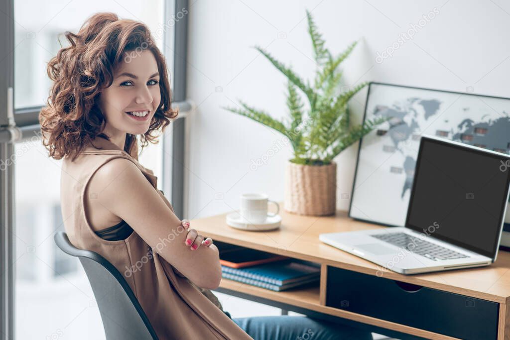 Dark-haired young woman working in the office