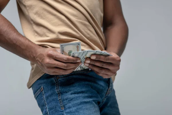 Mans hands pulling out banknotes from his pocket — Stock Photo, Image