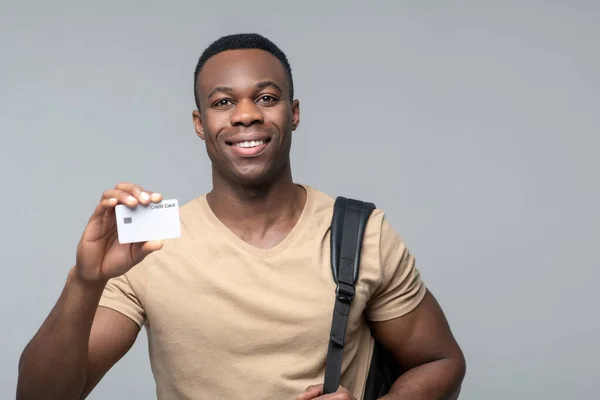 Feliz sonriente afroamericano mostrando tarjeta de crédito — Foto de Stock