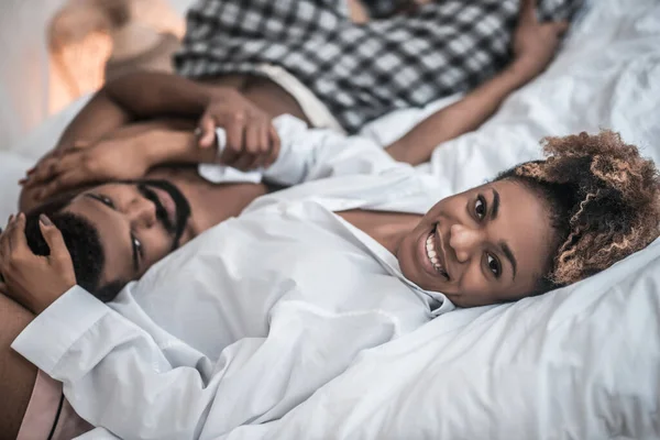 Joyful Africano americano mulher abraçando marido na cama — Fotografia de Stock