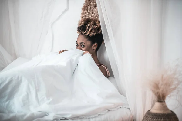 침대에 하얀 담요를 두른 아프리카 계 미국인 여성 — 스톡 사진