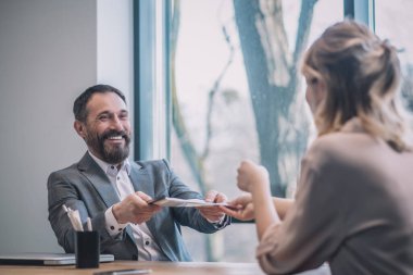 Neşeli patron kadınlardan dosya dosyalarını alıyor