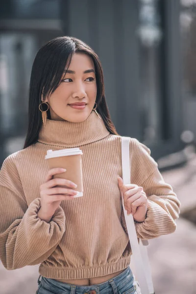 Dark-haired young asian woman with a cup of coffee — Stock Photo, Image