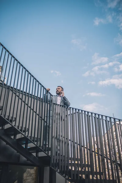 Ο άνθρωπος μιλάει σε σκάλες αναρρίχησης smartphone — Φωτογραφία Αρχείου